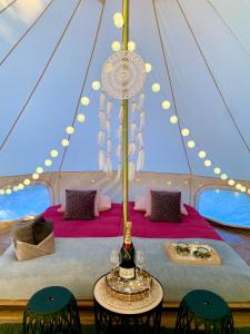 a tent with a table and chairs in it at Caravana Juliana - Glamping in Swaderki