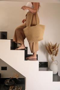 a woman is standing on the top of some stairs at Iphimedeia Luxury Hotel & Suites in Naxos Chora