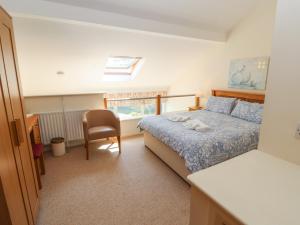 a bedroom with a bed and a desk and a chair at Ash Meadows in Carnforth