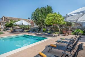 a pool with chaise lounge chairs and a table at Sa Barcella TI 64 in Sineu