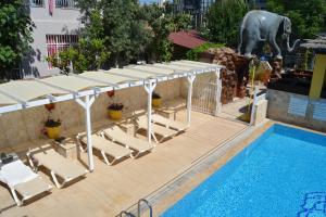 a pool with lounge chairs and a canopy and a swimming pool at Safari Suit N-6 in Side
