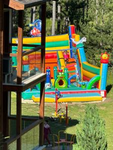 a playground with a brightly colored play equipment at Entire Private Apartment in Pirin Golf & Country Club in Bansko