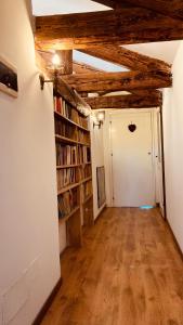 a hallway with bookshelves and a white wall at Cà Sardi in Venice