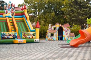 a playground with a slide and a play structure at Hotel Atlantic Costinesti in Costinesti