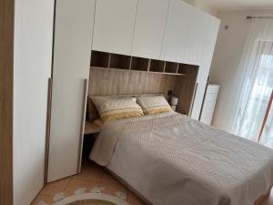 a bedroom with a large bed with a wooden headboard at Casa Palma in San Donato