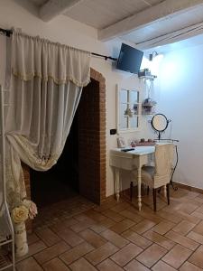 a living room with a table and a curtain at Lo scrigno di Simon in Senigallia
