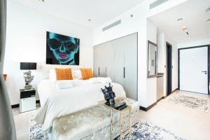 a bedroom with a large bed with a black face on the wall at The Suite Dubai 15 Northside Luxury Living in Dubai