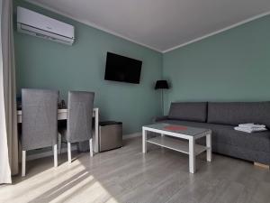 a living room with a couch and a table at Villa Bianco in Międzyzdroje