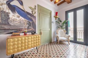 a bedroom with a large painting of a bird on the wall at Dog Admiral - Urban Guest House in Palma de Mallorca