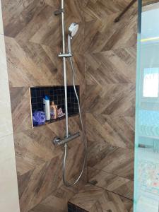 a shower in a bathroom with a wooden floor at VillaLina Haut Standing Djerba in Ajim