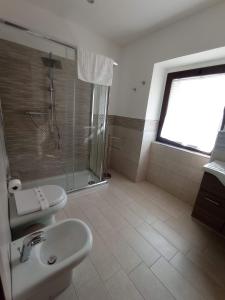 a bathroom with a toilet and a sink and a shower at Villa Alfea CAMERE in Porto Cesareo