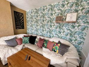 a living room with a couch with colorful pillows at Luxury Loft suite ideal theatre digs in Blackpool