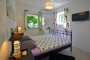 a small bedroom with a bed and a tv at Terrace Apartment in Hvar