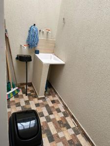 a small bathroom with a sink and a counter at Apto-Parking cerca CC Gran Plaza in Pitalito
