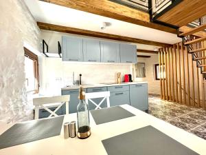 a kitchen with a bottle of wine on a counter at Apartments Angela in Piran
