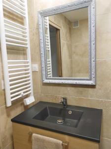 baño con lavabo negro y espejo en *Tout confort*4 pers*Centre Isola 2000, en Isola