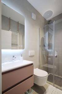a bathroom with a sink and a toilet and a shower at Apartments Maestral in Medulin