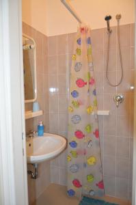 a bathroom with a shower curtain with a sink at Affittacamere Mirella in Pineto +33 photos