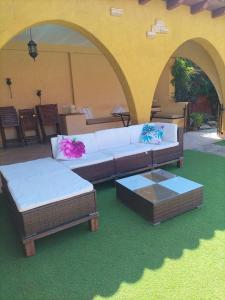 a living room with a couch and two ottoman at Casa Rural Lares in Casas de Don Pedro