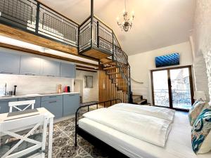 a bedroom with a bed and a spiral staircase at Apartments Angela in Piran