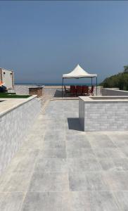 a patio with a table and a gazebo at شاليه فندقي بحمام سباحه خاص داخل فندق ايليت ريزيدنس اند اكوا بارك in Ain Sokhna