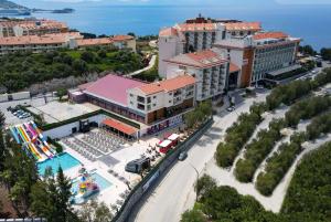 an aerial view of a resort with a pool at Ramada Hotel & Suites by Wyndham Kusadasi in Kusadası