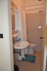 a bathroom with a sink and a toilet at Affittacamere Mirella in Pineto