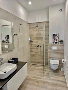 a bathroom with a shower and a toilet and a sink at Villa Night Pearl in Trogir