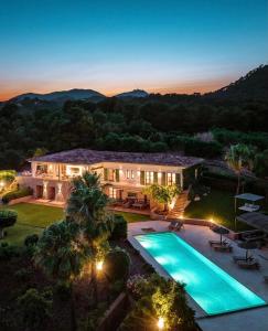 a large house with a swimming pool in the yard at Villa Golf D'or in Portocolom