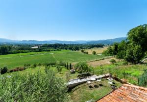 an aerial view of a farm with a train in a field at Villa Colle di Giotto Mugello, Tuscany in Borgo San Lorenzo