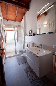 a white bathroom with a sink and a toilet at Villa Colle di Giotto Mugello, Tuscany in Borgo San Lorenzo