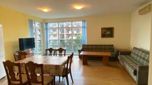 a living room with a table and a couch at Prostor Apartments in Obzor
