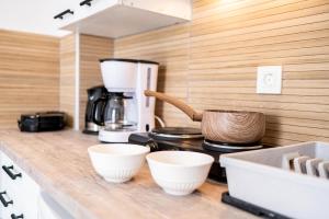 a kitchen counter with two white bowls and a coffee maker at Kos Olympia Apartment superior at Lambi Beach in Kos