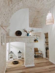 ein Wohnzimmer mit einem Steinkamin und einem Stuhl in der Unterkunft Casa De Amicis in Sammichele di Bari