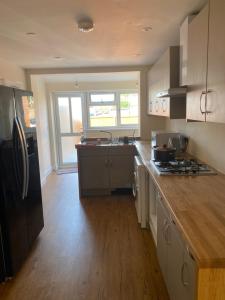 a kitchen with a counter top and a refrigerator at Plumpton Walk in Canterbury