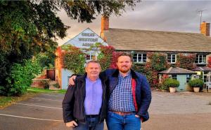 two men are standing in front of a building at The Great Western Arms in Clifton Hampton