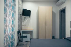 Televízia a/alebo spoločenská miestnosť v ubytovaní BluMarine Appartaments
