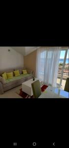 a living room with a couch and a table at Apartman Milovic in Tivat