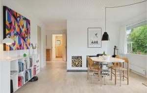 a kitchen and dining room with a table and chairs at Cozy Home In Nivå With Kitchen in Nivå