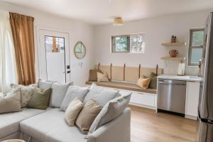 a living room with a white couch and a bench at The Laurel Loft in San Diego