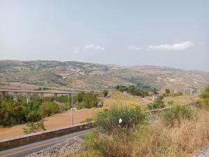 a road on a hill with a view of a valley at Santiago Rooms in Caltagirone