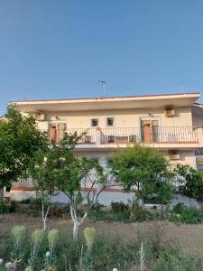 a building with trees in front of it at Seaview Saravari Studios in Áyios Aléxandros