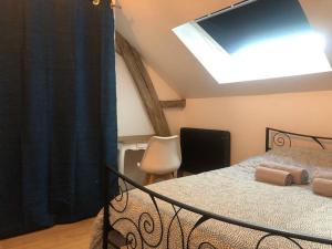 a bedroom with a bed with a skylight at Le Domremy F2 au cœur d'Orléans in Orléans