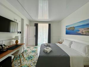 Cama ou camas em um quarto em TEA Luxury - Praia a Mare