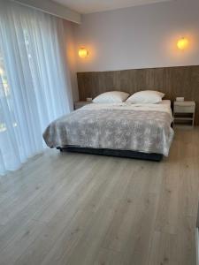 a bedroom with a bed and a wooden floor at Willa Bursztyn Gdansk in Gdańsk