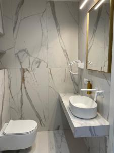a white bathroom with a sink and a toilet at Willa Bursztyn Gdansk in Gdańsk +54 photos