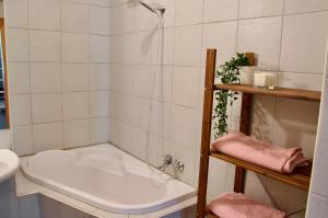 a bath tub in a bathroom next to a sink at Elephants Apartments in Bratislava