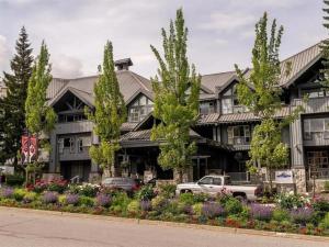 a building with a truck parked in front of it at Stunning 2BR w Pool, Hot Tub Walk to everything! in Whistler