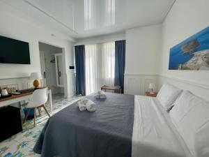 Cama ou camas em um quarto em TEA Luxury - Praia a Mare