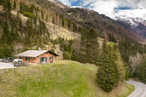 a house in the mountains with a road next to it at Gemütliches Ferienhaus im Defereggental 